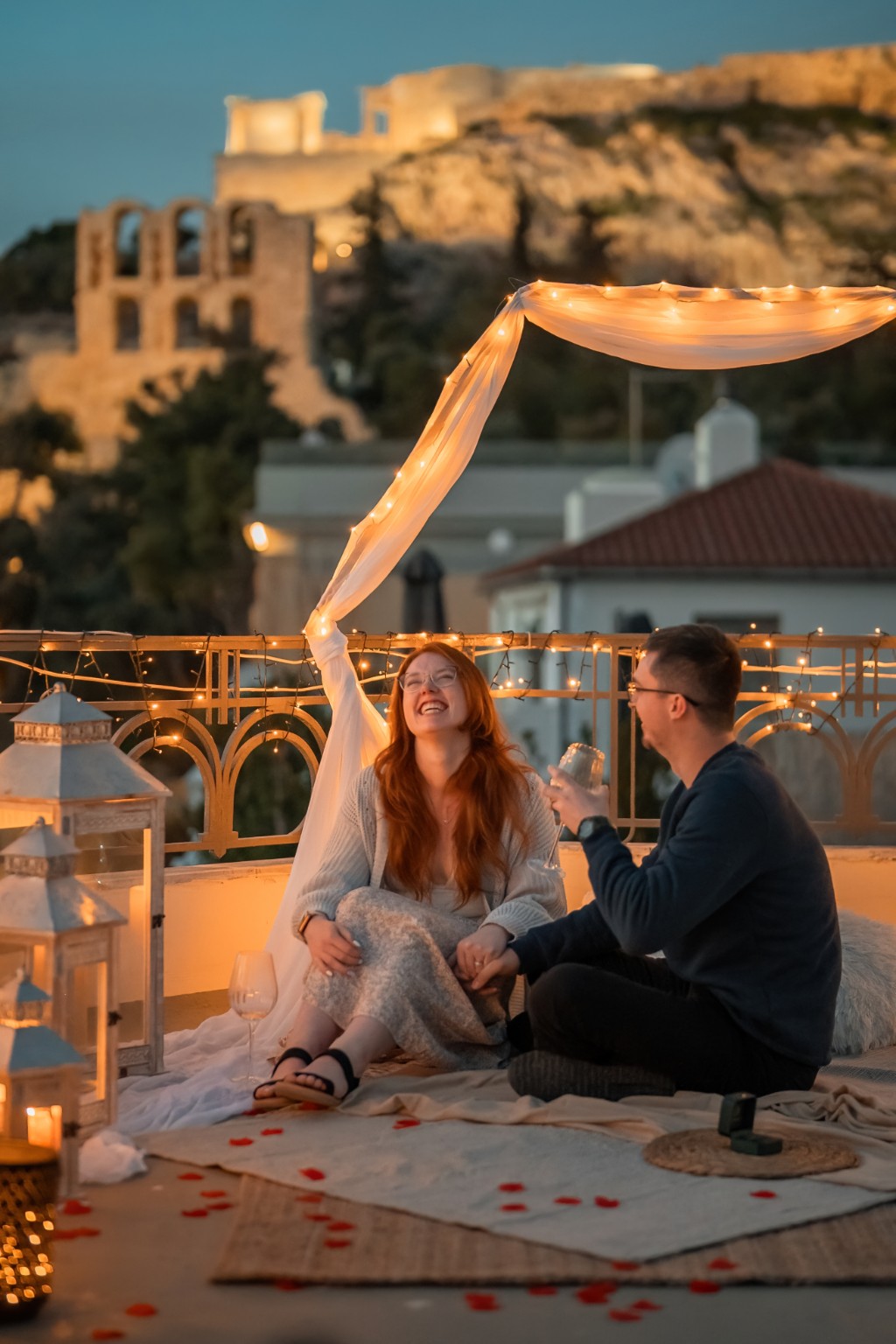 Newly engaged pair laughing after their surprise proposal